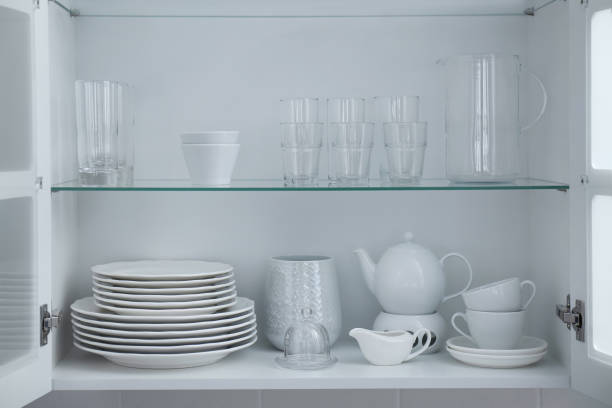 istock Cabinet with crockery and glassware. Order in kitchen 1354308225