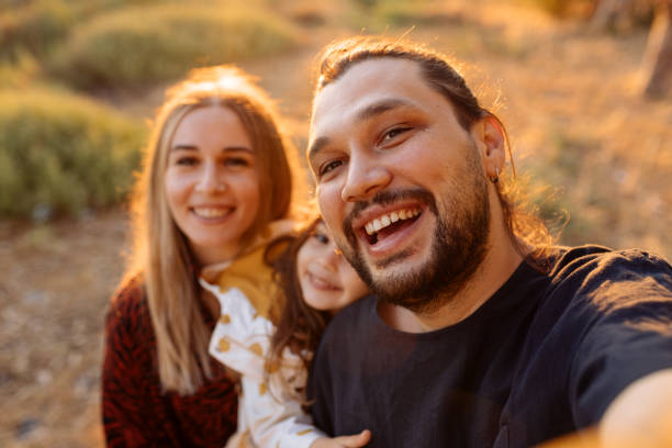 istock Happy family in nature at sunset 1354308946