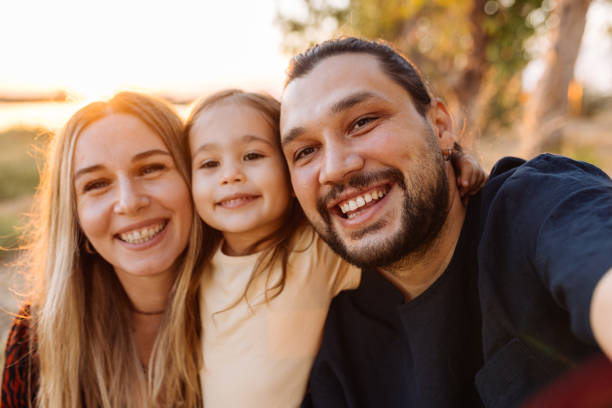 istock Happy family in nature at sunset 1354309168