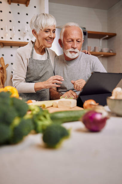 istock a happy senior couple preparing a healthy meal together, using a tablet 1354309171