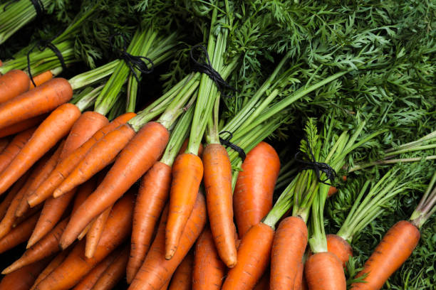 istock Bunches of tasty raw carrots as background 1354312640