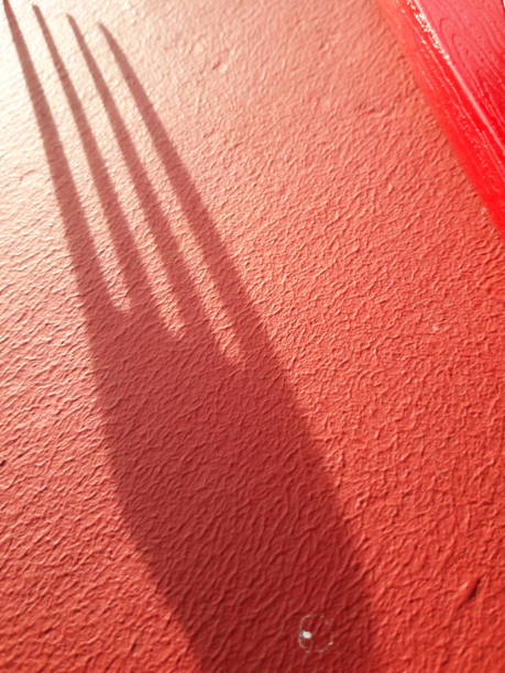istock The fork and its shadow on a red background highlighted by the rising sun 1354336846