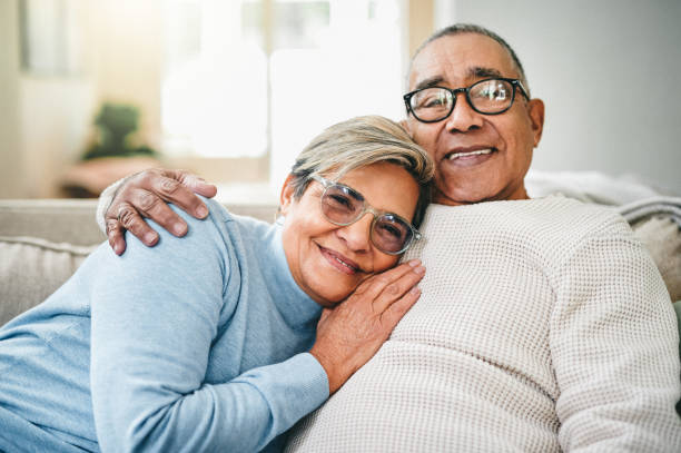 foto de una pareja de ancianos relajándose en el sofá de casa - wife expressing positivity content loving fotografías e imágenes de stock