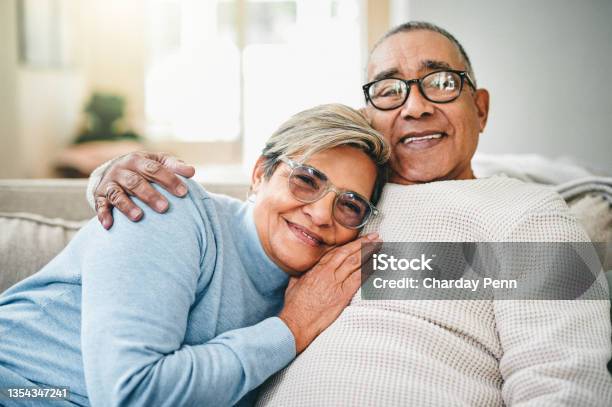 Shot Of A Senior Couple Relaxing On The Couch At Home Stock Photo - Download Image Now