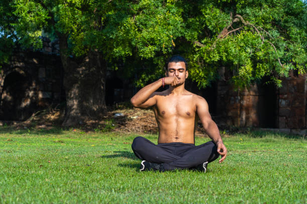 istock young muscular man doing yoga on grass on a sunny day 1354348976
