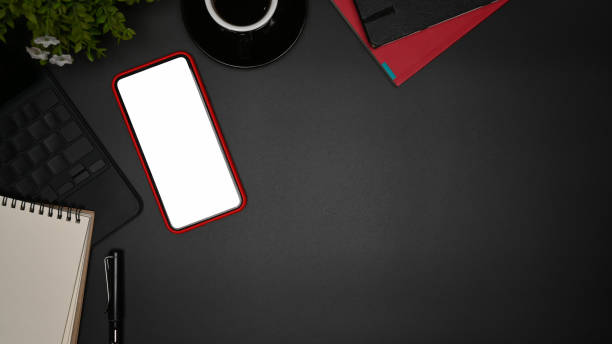 istock Above view mock up smart phone with empty display on black background. 1354350431