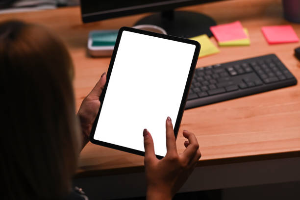 istock Close up view young woman holding digital tablet with blank display. 1354350537