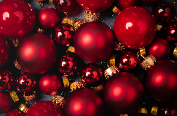 istock Red christmas balls on the black stone background 1354350736