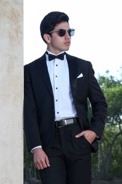 istock Young model wearing an elegant black tuxedo 1354356315