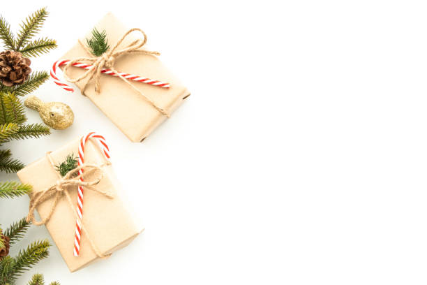 istock Beautiful Christmas background with two gift boxes, decorate with pine branch and pine cone over white background. Top view with copy space, flay lay. 1354359406