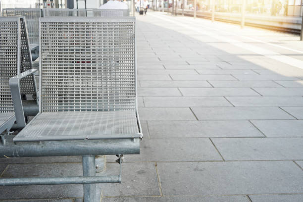 istock Empty waiting chairs on the platform in the  Train station. 1354360932