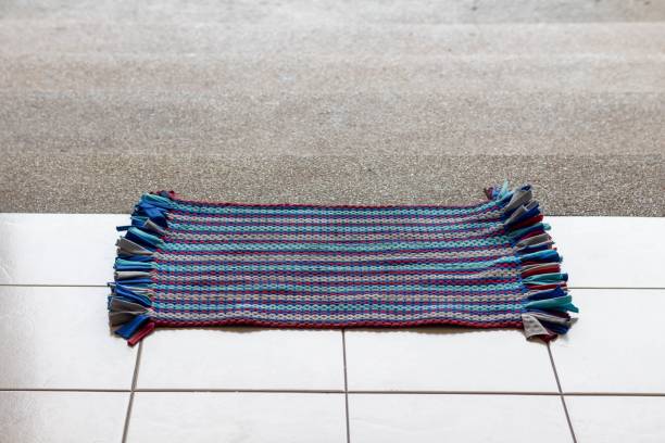 The doormat is in front of the stairs before entering the building. stock photo