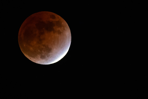 A close up of a full moon partial lunar eclipse