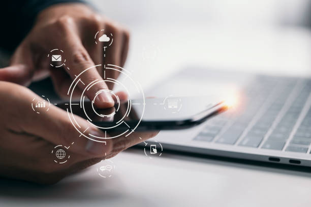 istock Multichannel online banking payment network communication with a man's hand holding a smartphone with a graphic icon. 1354363980