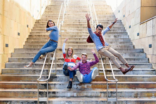 istock Multicultural group of excited friends cheering and laughing 1354366230