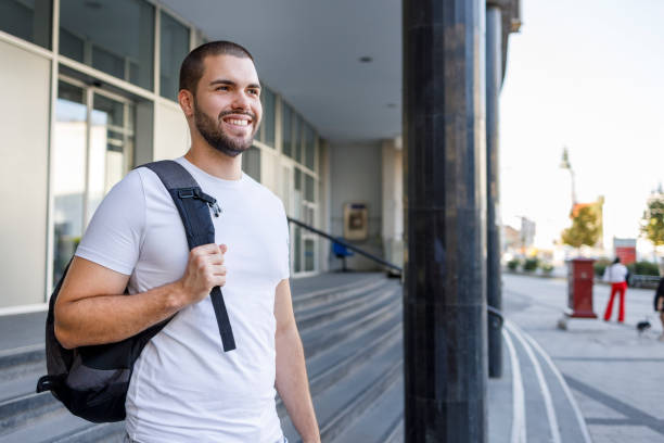 istock Happy male student wearing a backpack 1354366535