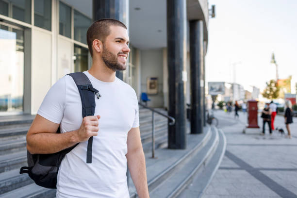 istock Male student wearing a backpack and smiling 1354366536
