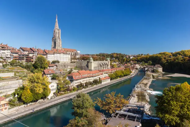 The cathedral of Bern or Munster along side of Aare river in sunny day, Switzerland tourism