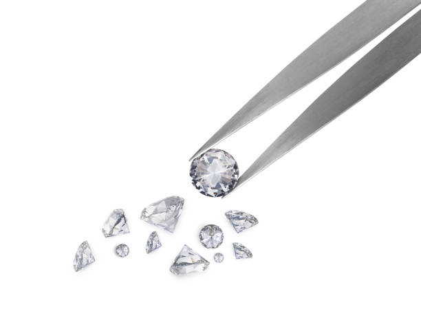 istock brilliant cut diamond held by tweezers isolated on white background 1354372779