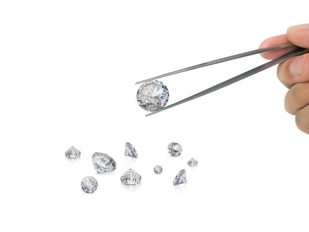 istock brilliant cut diamond held by tweezers isolated on white background 1354372803
