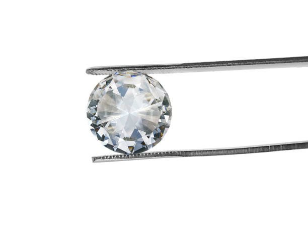istock brilliant cut diamond held by tweezers isolated on white background 1354372830
