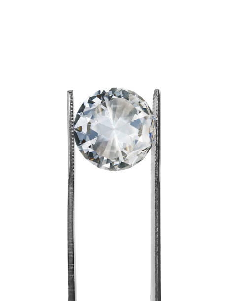 istock brilliant cut diamond held by tweezers isolated on white background 1354372845