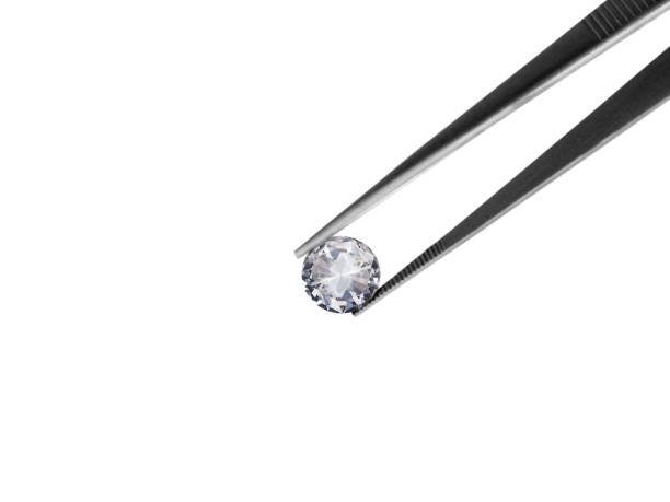 istock brilliant cut diamond held by tweezers isolated on white background 1354372876