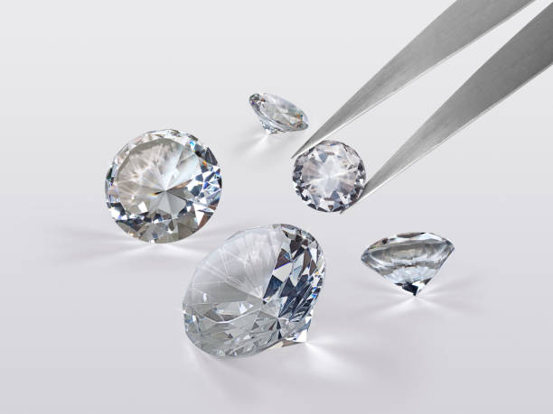 istock brilliant cut diamond held by tweezers isolated on white background 1354372926
