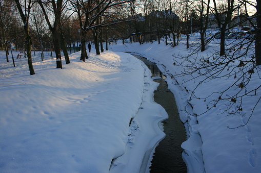 Cold winter and white snow in the city park