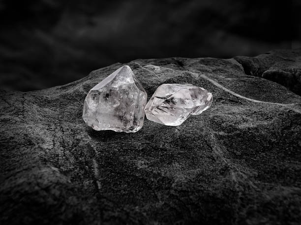 istock Natural diamond nestled on black coal background 1354378226