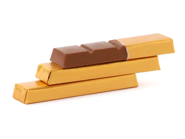 Chocolate bars wrapped in golden aluminum foil isolated on white, sweet food
