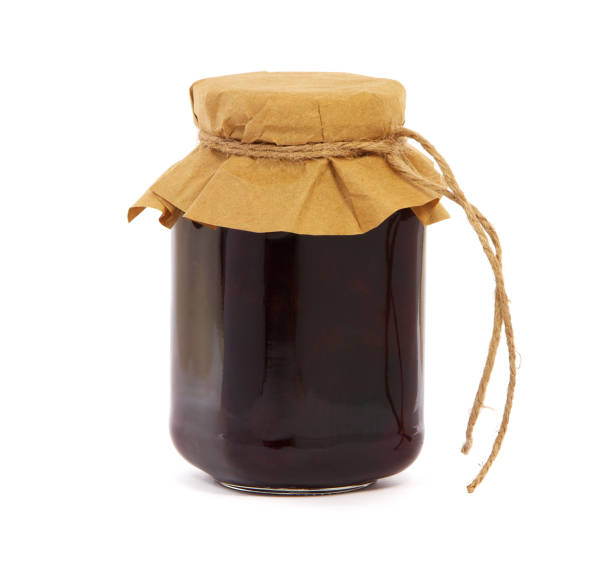istock Plum jam in a glass jar isolated on white background 1354381681