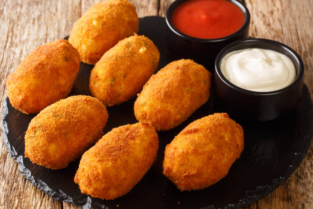 istock Croquetas de Bacalao Cod Croquettes with sauces close up in the slate plate . Horizontal 1354383373