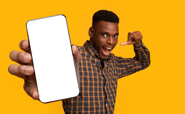 istock Modern smartphone with empty screen in african american man hand 1354385715