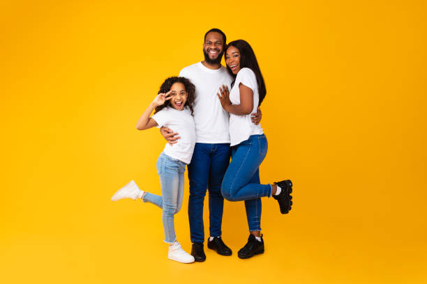 istock African American man hugging his wife and playful daughter 1354388564
