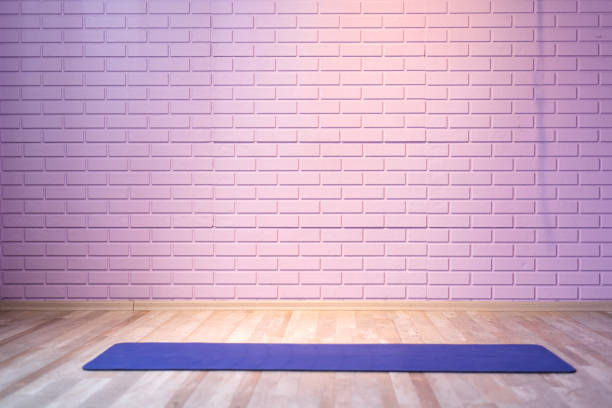 istock Empty room background wooden floor pink brick wall fit mat 1354389442