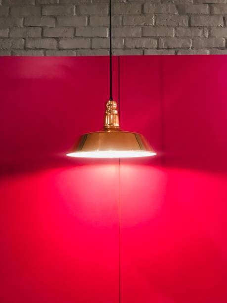 istock Hanging lamp on the red wall 1354389570