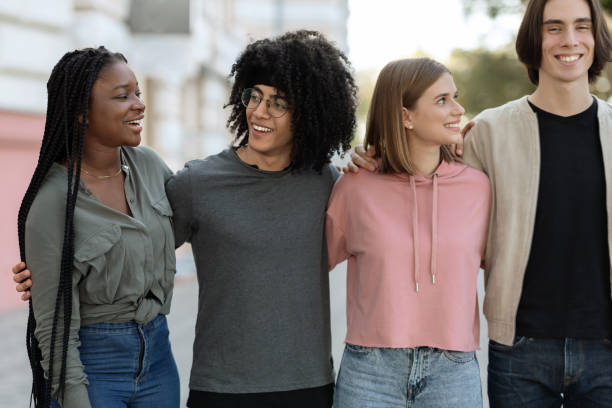 istock Multiracial group of cheerful millennials spending time together 1354391067