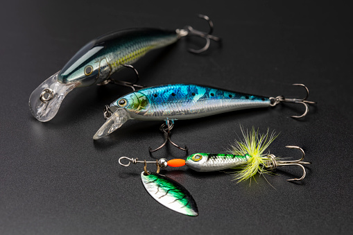 Artificial baits for catching of the predatory fishes on black background