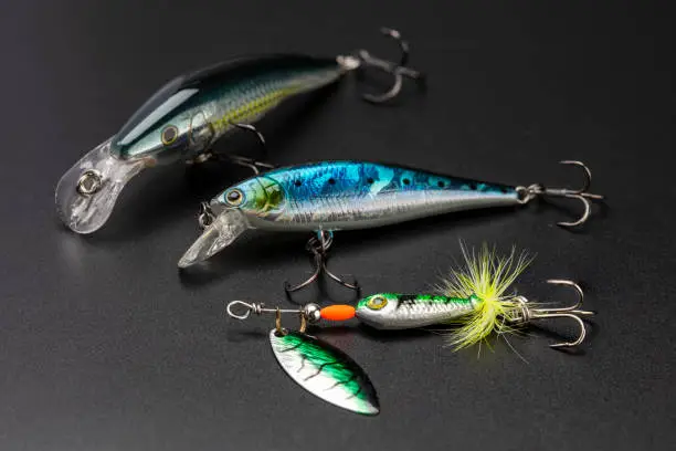 Photo of Artificial baits for catching of the predatory fishes on black background