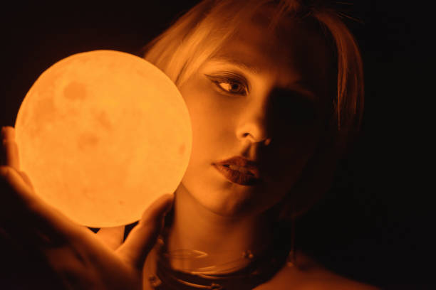 istock Woman holding a glowing moon. 1354396053