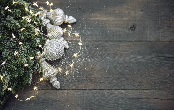 istock Christmas decoration silver ornaments golden lights dark background 1354397441