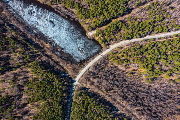 istock Aerial view over bridge on small river and the forest, spring Sunny day, Central Russia 1354397713