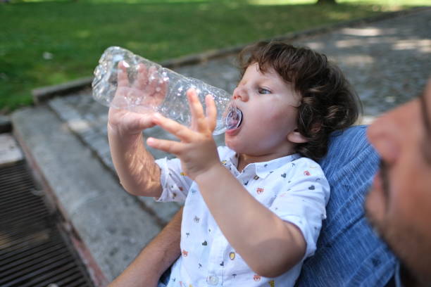 istock A child is drinking clean water from a bottle. Hot summer day. 1354397945