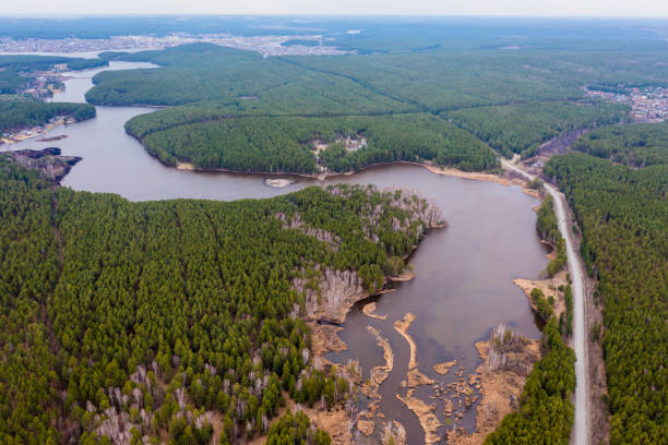 istock Green forest, swamp and small river captured from above with drone. 1354398944