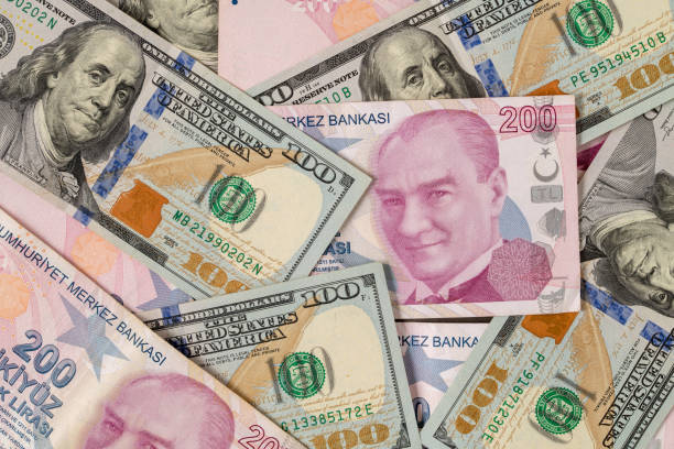 us dollars and turkish liras on top of each other completely covering the screen - tl imagens e fotografias de stock