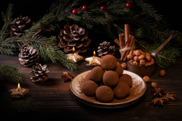 sweets and Christmas decorations chocolate truffles, with spices and Christmas decorations. Christmas composition tartuffo stock pictures, royalty-free photos & images