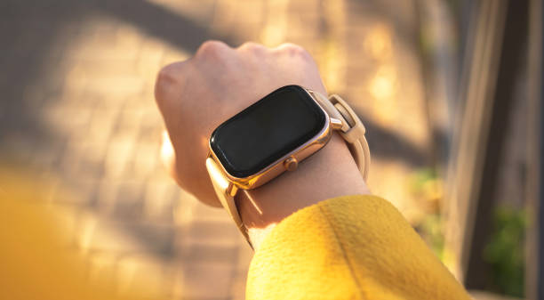 istock Woman uses modern smart watch outdoors close-up view 1354400529