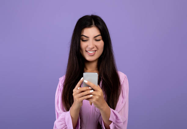 istock Modern communication. Happy armenian woman browsing on smartphone, messaging or scrolling social networks feed 1354401651