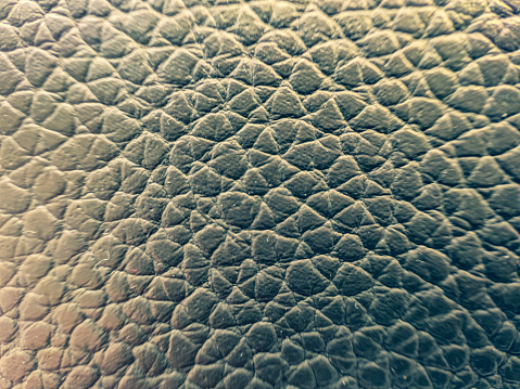 A macro image of a light brown leather.